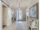 Inviting foyer features neutral decor, stylish lighting, and access to various living areas at 10978 Laxer Cay Loop, San Antonio, FL 33576