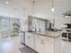 Island with seating, open to the dining and living areas of this home. Granite countertops at 10978 Laxer Cay Loop, San Antonio, FL 33576