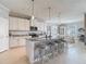 Open kitchen with a large island, seating, and stainless steel appliances, perfect for entertaining guests at 10978 Laxer Cay Loop, San Antonio, FL 33576