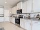 Well-appointed kitchen featuring granite countertops, stainless steel appliances, and ample cabinet storage at 10978 Laxer Cay Loop, San Antonio, FL 33576
