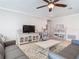 Cozy living room with ample seating, neutral tones, and a modern entertainment center at 10978 Laxer Cay Loop, San Antonio, FL 33576