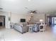 Spacious living room features stylish furniture, neutral decor, and seamless flow into the foyer at 10978 Laxer Cay Loop, San Antonio, FL 33576