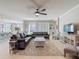 Spacious living room with stylish sofas, ceiling fan, and neutral tones, creating a welcoming atmosphere at 10978 Laxer Cay Loop, San Antonio, FL 33576