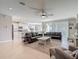 Open-concept living room flows into a modern kitchen, perfect for entertaining guests at 10978 Laxer Cay Loop, San Antonio, FL 33576
