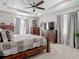 The main bedroom features large windows, ceiling fan, and stylish décor at 10978 Laxer Cay Loop, San Antonio, FL 33576