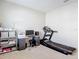 Bright office space with a comfortable treadmill, desk, and storage shelves at 10978 Laxer Cay Loop, San Antonio, FL 33576