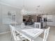 Bright open concept featuring tiled floors, modern kitchen, and elegant chandelier at 10978 Laxer Cay Loop, San Antonio, FL 33576