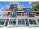 Modern multi-story building featuring orange balcony railings and large retail windows at 11 29Th N St, St Petersburg, FL 33713
