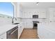 Well-lit kitchen with stainless steel appliances, white cabinets and countertops at 11 29Th N St, St Petersburg, FL 33713