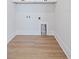 Empty laundry room with wood floors and white walls at 11 29Th N St, St Petersburg, FL 33713