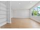 Bright living room features wood-look floors, recessed lighting, and a large window for plenty of natural light at 11 29Th N St, St Petersburg, FL 33713