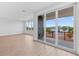 Bright living space with sliding glass doors to a balcony, complemented by wood-look flooring at 11 29Th N St, St Petersburg, FL 33713