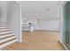 Open-concept living space connects to a modern kitchen, highlighted by wood-look floors and staircase at 11 29Th N St, St Petersburg, FL 33713