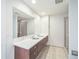 Bathroom featuring a dual sink vanity, a large mirror, and tiled flooring at 1120 E Kennedy Blvd # 615, Tampa, FL 33602