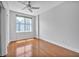 Bright bedroom featuring hardwood floors, a ceiling fan and a large window at 1120 E Kennedy Blvd # 615, Tampa, FL 33602