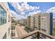 Street view of multi-story condo buildings from a balcony, showing the street and blue sky at 1120 E Kennedy Blvd # 615, Tampa, FL 33602
