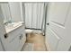 Tiled bathroom features a white vanity and shower with curtain at 11268 Fieldstone Dr, Palmetto, FL 34221
