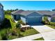 Charming single-story home with a well-manicured lawn and a two-car garage, showcasing its inviting curb appeal at 11268 Fieldstone Dr, Palmetto, FL 34221