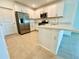 Well-lit kitchen featuring stainless steel appliances, white cabinetry, and a functional layout for meal preparation at 11268 Fieldstone Dr, Palmetto, FL 34221