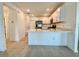 Modern kitchen with white cabinets, stainless steel appliances, and a breakfast bar, offering a stylish cooking space at 11268 Fieldstone Dr, Palmetto, FL 34221