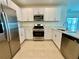 Close-up of the kitchen featuring stainless steel appliances, ample counter space, and modern cabinetry at 11268 Fieldstone Dr, Palmetto, FL 34221