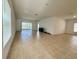 Bright, open living room featuring tile flooring and a sliding glass door, creating a seamless indoor-outdoor transition at 11268 Fieldstone Dr, Palmetto, FL 34221