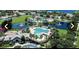 An aerial view shows the community amenities including swimming pools, clubhouse, playgrounds, and ponds with fountain features at 11468 Captiva Kay Dr, Riverview, FL 33569