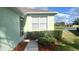 Home exterior with a manicured lawn and view of the pond at 11468 Captiva Kay Dr, Riverview, FL 33569