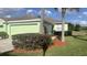 Single-story home with a well-maintained lawn, mature bushes, and a two-car garage at 11468 Captiva Kay Dr, Riverview, FL 33569