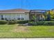 Well-maintained backyard with lush green grass and a screened-in patio perfect for outdoor living at 13539 Circa Crossing Dr, Lithia, FL 33547