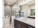 Well-lit bathroom featuring a double vanity, a walk-in shower, and modern fixtures at 13539 Circa Crossing Dr, Lithia, FL 33547