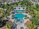 Aerial view of community pool, with area, large pool, cabanas, palm trees and lounge chairs at 13539 Circa Crossing Dr, Lithia, FL 33547