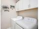 Bright laundry room with modern washer and dryer, plenty of storage space, and laundry decor at 13539 Circa Crossing Dr, Lithia, FL 33547