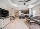 Spacious open-concept living area with tile floors, abundant natural light, and modern furnishings at 13539 Circa Crossing Dr, Lithia, FL 33547