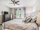 Serene main bedroom featuring a large window, plush bedding, and calming decor at 13539 Circa Crossing Dr, Lithia, FL 33547