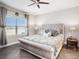 Inviting main bedroom with decorative curtains, a comfortable bed, and side tables with lamps at 13539 Circa Crossing Dr, Lithia, FL 33547