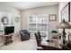 Well-lit home office featuring a large window, comfortable seating, and a spacious desk at 13539 Circa Crossing Dr, Lithia, FL 33547