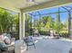 Spacious screened-in patio with comfortable seating and picturesque backyard views at 13539 Circa Crossing Dr, Lithia, FL 33547