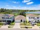 Aerial view of homes with well-maintained lawns in a lakeside community on a sunny day at 13757 Wineberry Dr, Dade City, FL 33525