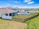Aerial view of the backyard featuring black and white fences surrounding the well-maintained lawn at 13757 Wineberry Dr, Dade City, FL 33525