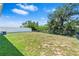 Backyard featuring an expansive lawn, fenced perimeter, and mature trees at 13757 Wineberry Dr, Dade City, FL 33525