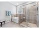 Neutral bathroom featuring a separate tub and shower, tiled walls, and modern fixtures at 13757 Wineberry Dr, Dade City, FL 33525