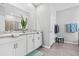 Bright bathroom featuring dual sinks with granite countertops and a glass-enclosed shower at 13757 Wineberry Dr, Dade City, FL 33525