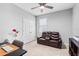 Functional bedroom with a desk, comfortable seating, and ample natural light, perfect for work or relaxation at 13757 Wineberry Dr, Dade City, FL 33525