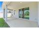 Spacious covered patio featuring sliding glass doors and a view of the backyard at 13757 Wineberry Dr, Dade City, FL 33525