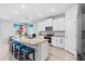 Modern kitchen featuring white cabinets, stainless steel appliances, and a granite island at 13757 Wineberry Dr, Dade City, FL 33525