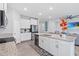 Kitchen featuring white cabinets, granite countertops, stainless appliances, and island seating at 13757 Wineberry Dr, Dade City, FL 33525