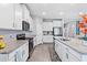 Spacious kitchen with white cabinets, granite countertops, and stainless steel appliances at 13757 Wineberry Dr, Dade City, FL 33525