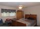 Traditional bedroom with a ceiling fan, a wooden wardrobe, and window with horizontal blinds at 1395 Heather Ridge Blvd, Dunedin, FL 34698