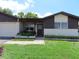 Charming single-story home with a well-maintained lawn and manicured landscaping at 1395 Heather Ridge Blvd, Dunedin, FL 34698